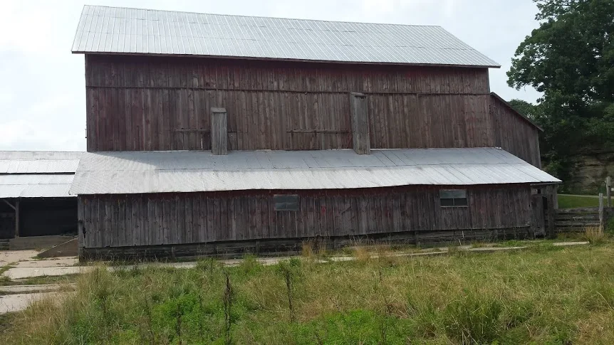 The weathered barn exterior before the conversion.