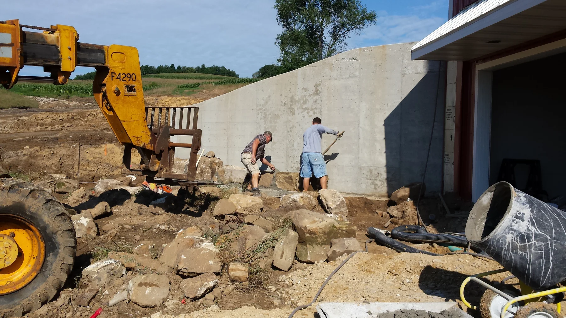 Building the stone retaining wall beside the barn.
