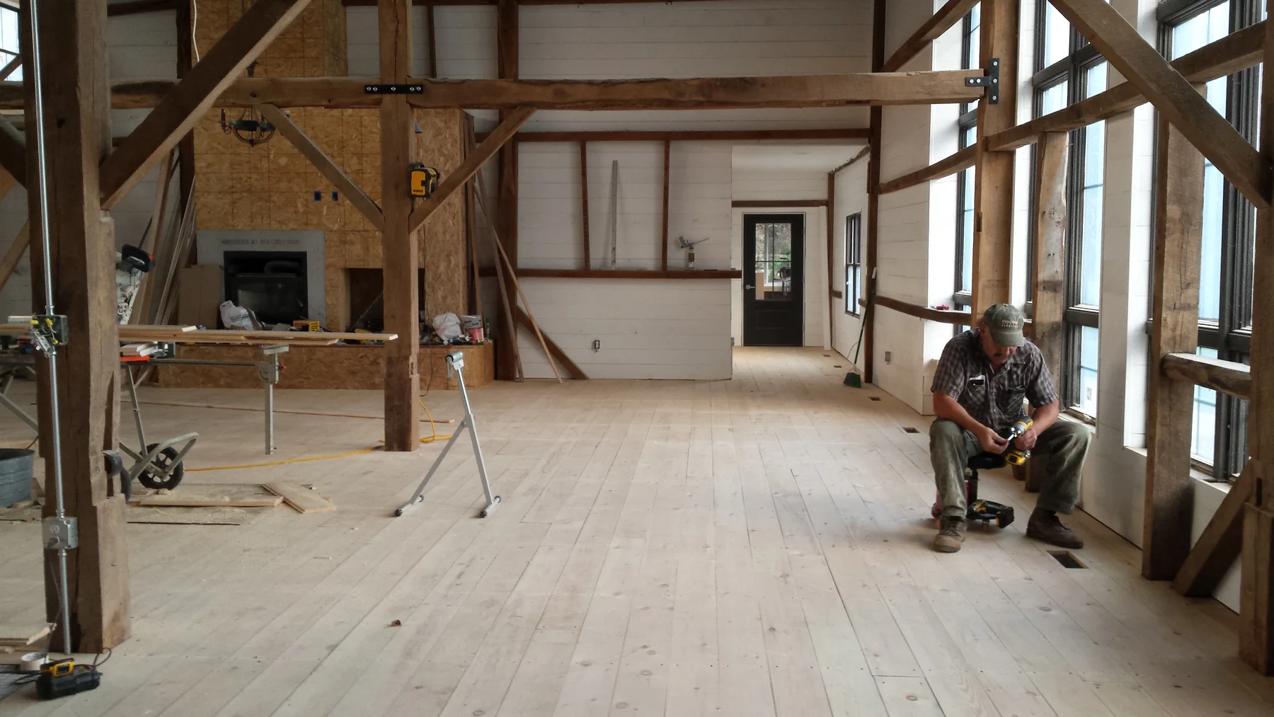 Interior work moving through the open barn frame.