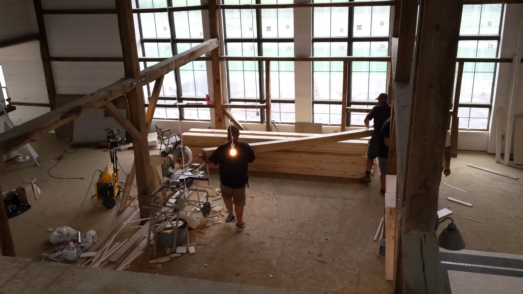 Work underway beneath the tall window wall.