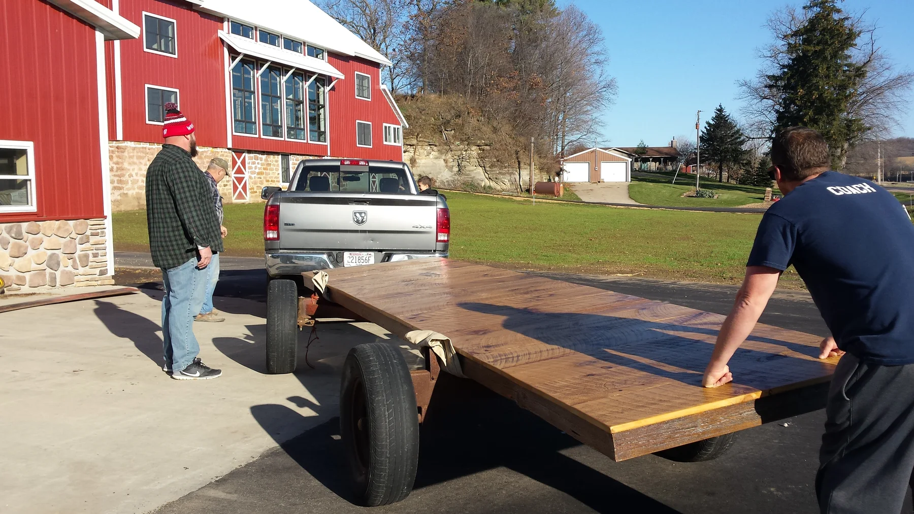 The finished table being carried from the shop.