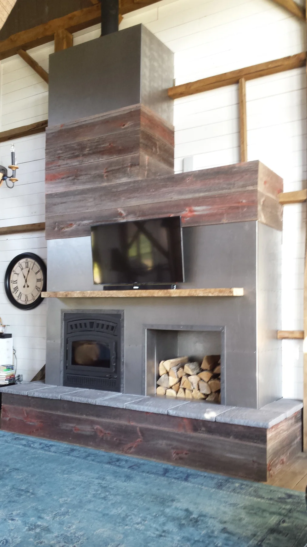 The completed fireplace with the salvaged dinner bell above.