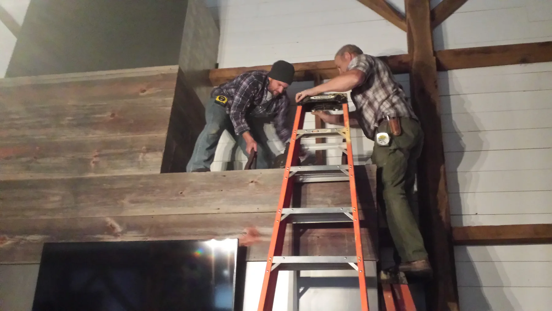 The dinner bell being placed over the fireplace.