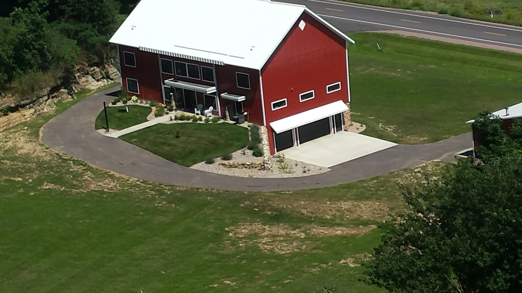 An aerial view of the barn after landscaping and exterior work.
