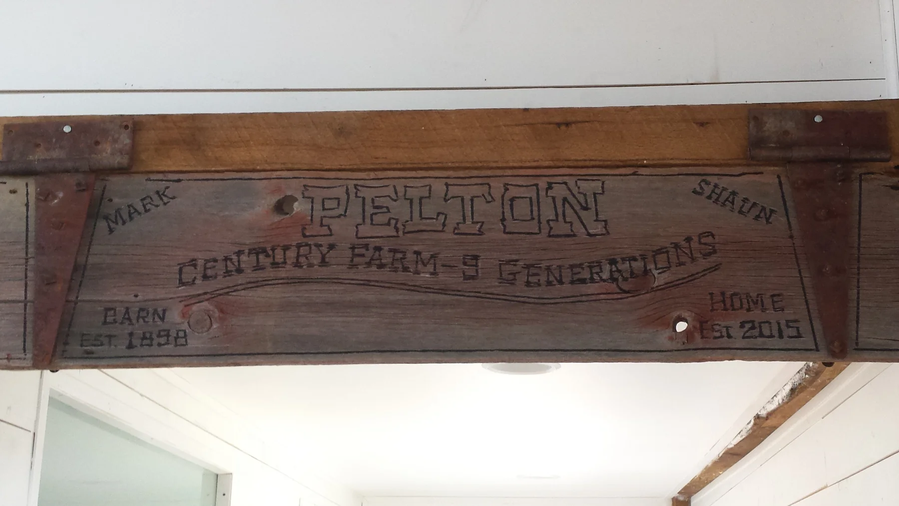 The barn-wood sign made from old material and hinges.