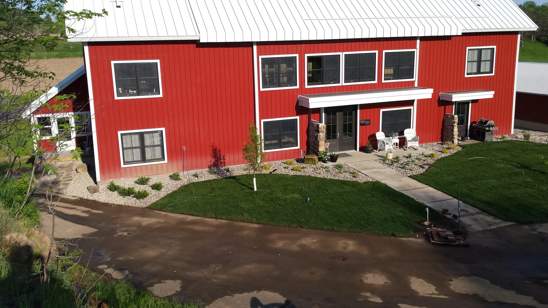 The front of the barn after sod and planting work.